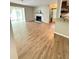 Open concept living room with fireplace, wood flooring, and natural light from the bay window at 2107 Augusta Se Dr, Marietta, GA 30067