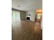 Bright living room featuring wood flooring, a fireplace with white mantle, and large windows at 2107 Augusta Se Dr, Marietta, GA 30067