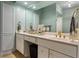 Bathroom with white cabinets, dual sinks, gold fixtures, and a large mirror at 3777 Peachtree Ne Rd # 1112, Brookhaven, GA 30319