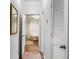 Hallway with hardwood floors leading to a bedroom; mirror hanging on the wall at 3777 Peachtree Ne Rd # 1112, Brookhaven, GA 30319