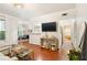 Bright living room features hardwood floors, a large television, and a view into dining area at 3777 Peachtree Ne Rd # 1112, Brookhaven, GA 30319