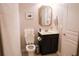 Well-lit bathroom with stylish vanity, framed mirror, and tiled flooring at 6298 Pierless Ave, Sugar Hill, GA 30518