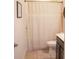 Cozy bathroom features shower/tub combo with neutral curtain and coordinated tile flooring at 6298 Pierless Ave, Sugar Hill, GA 30518