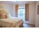 Cozy bedroom features natural light from the window and comfortable decor at 6298 Pierless Ave, Sugar Hill, GA 30518