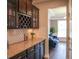 Convenient butlers pantry with granite countertops, wine rack and glass front cabinetry at 6298 Pierless Ave, Sugar Hill, GA 30518