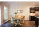 Cozy dining area with a round table, four chairs, and bright natural light from a nearby window at 6298 Pierless Ave, Sugar Hill, GA 30518