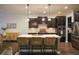 Bright kitchen featuring an island with seating, sleek stainless steel appliances, and dark cabinetry at 6298 Pierless Ave, Sugar Hill, GA 30518