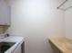 Convenient laundry room with washer, dryer, and built-in folding table at 6298 Pierless Ave, Sugar Hill, GA 30518