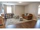 Inviting living room with hardwood floors, cozy seating, and natural light at 6298 Pierless Ave, Sugar Hill, GA 30518