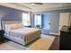 Spacious main bedroom with blue walls, hardwood floors, and a ceiling fan at 6298 Pierless Ave, Sugar Hill, GA 30518