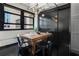 Dining area with a wooden table, black metal chairs, and modern light fixture at 878 Peachtree St # 601, Atlanta, GA 30309