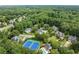 An aerial view of a residential neighborhood with a tennis court, swimming pool, and lush green trees at 2015 Samuel Close Ct, Alpharetta, GA 30009