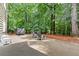 Large backyard with concrete patio, seating and mature trees, offering a private outdoor space at 2015 Samuel Close Ct, Alpharetta, GA 30009