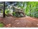 Backyard with tiered deck, patio, and natural landscaping, perfect for outdoor entertaining at 2015 Samuel Close Ct, Alpharetta, GA 30009