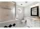 Bathroom featuring patterned floor, window, shower with glass door and vanity at 2015 Samuel Close Ct, Alpharetta, GA 30009