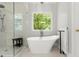 Bright bathroom features stand alone tub and glass shower at 2015 Samuel Close Ct, Alpharetta, GA 30009