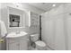 Bathroom featuring a white vanity, mirror, toilet, and shower with a white curtain at 2015 Samuel Close Ct, Alpharetta, GA 30009