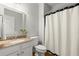 Clean bathroom has granite countertops, framed mirror, and tub with shower perfect for modern comfortable living at 2015 Samuel Close Ct, Alpharetta, GA 30009