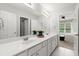 This bathroom features double sinks and a view of the bedroom at 2015 Samuel Close Ct, Alpharetta, GA 30009