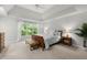 Bright, spacious bedroom features tray ceilings, neutral carpeting, bench seating and large windows at 2015 Samuel Close Ct, Alpharetta, GA 30009