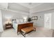 Bright bedroom features tray ceilings, neutral carpeting, bench seating and side table with lamp at 2015 Samuel Close Ct, Alpharetta, GA 30009