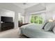 Bright bedroom features large windows, soft carpet and a blue quilt at 2015 Samuel Close Ct, Alpharetta, GA 30009