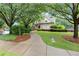 A clubhouse nestled among mature trees, featuring a curved walkway and well-maintained landscaping at 2015 Samuel Close Ct, Alpharetta, GA 30009