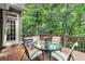 Charming deck area with glass table and chairs, offering an ideal spot for outdoor relaxation and dining at 2015 Samuel Close Ct, Alpharetta, GA 30009
