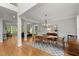 Open dining room with hardwood flooring, chandelier, and decorative rug at 2015 Samuel Close Ct, Alpharetta, GA 30009