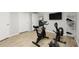 Basement exercise room equipped with stationary bike, rowing machine and shelving at 2015 Samuel Close Ct, Alpharetta, GA 30009