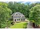 Beautiful home with landscaped front yard, porch and surrounded by lush green trees at 2015 Samuel Close Ct, Alpharetta, GA 30009