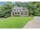 Attractive two-story home with a well-manicured lawn, showcasing its curb appeal and landscaped front yard at 2015 Samuel Close Ct, Alpharetta, GA 30009