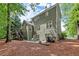 Back exterior view of home with deck, patio, and lush greenery, creating a serene setting at 2015 Samuel Close Ct, Alpharetta, GA 30009