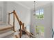 Grand foyer featuring a staircase, chandelier, and a view of the front entrance at 2015 Samuel Close Ct, Alpharetta, GA 30009