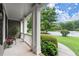 Inviting front porch features white columns, fresh flowers and view of manicured lawn at 2015 Samuel Close Ct, Alpharetta, GA 30009