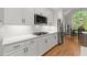 Stylish kitchen features white cabinets, stainless steel appliances, and hardwood floors, perfect for preparing gourmet meals at 2015 Samuel Close Ct, Alpharetta, GA 30009