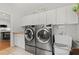 Bright laundry room featuring modern stainless steel appliances, sink and ample storage space at 2015 Samuel Close Ct, Alpharetta, GA 30009