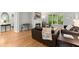 Bright living room boasts hardwood floors, fireplace, and large windows with a view of the landscaped backyard at 2015 Samuel Close Ct, Alpharetta, GA 30009