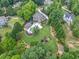 Aerial view showcasing the estate's expansive yard, pool, and lush surroundings at 407 Maple Ridge Ct, Cumming, GA 30028