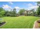 Spacious backyard with manicured lawn, landscaping, and outdoor entertaining area perfect for gatherings at 407 Maple Ridge Ct, Cumming, GA 30028