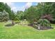 Beautiful backyard with a pond and lush landscaping, perfect for relaxation and outdoor enjoyment at 407 Maple Ridge Ct, Cumming, GA 30028