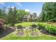 Intimate seating area in the backyard with mature landscaping and a view of the house at 407 Maple Ridge Ct, Cumming, GA 30028