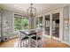 Bright breakfast nook with large windows, stylish light fixture and access to a screened in porch at 407 Maple Ridge Ct, Cumming, GA 30028