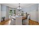 Elegant dining room with hardwood floors, wainscoting, and a stylish chandelier at 407 Maple Ridge Ct, Cumming, GA 30028