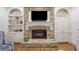 Close-up of the stone fireplace with built-in shelving, perfect for displaying décor at 407 Maple Ridge Ct, Cumming, GA 30028