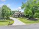 Well maintained home with a long driveway, mature trees, and lush landscaping at 407 Maple Ridge Ct, Cumming, GA 30028