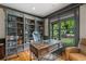 Beautiful home office with custom bookshelves, a comfortable desk, and natural light at 407 Maple Ridge Ct, Cumming, GA 30028