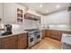 Gourmet kitchen featuring custom cabinets, stainless steel appliances, and a spacious layout at 407 Maple Ridge Ct, Cumming, GA 30028