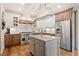 Gourmet kitchen with marble countertops, custom cabinets, and stainless steel appliances at 407 Maple Ridge Ct, Cumming, GA 30028