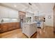 Island kitchen with marble countertops, stainless steel appliances, and stylish lighting fixtures at 407 Maple Ridge Ct, Cumming, GA 30028